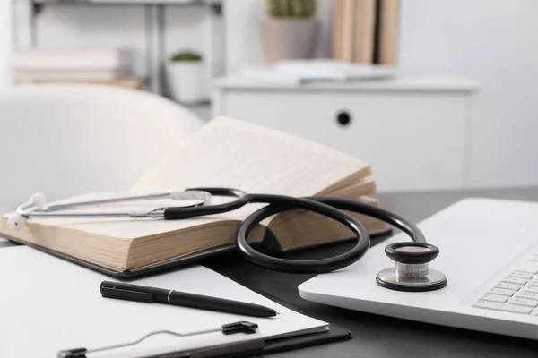 Open Student Textbook Clipboard Stethoscope Laptop Grey Table Indoors Closeup — Stock Photo, Image