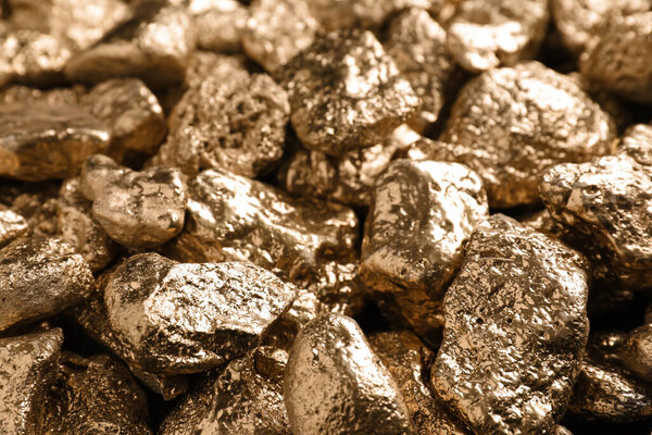 Pile of gold nuggets as background, closeup