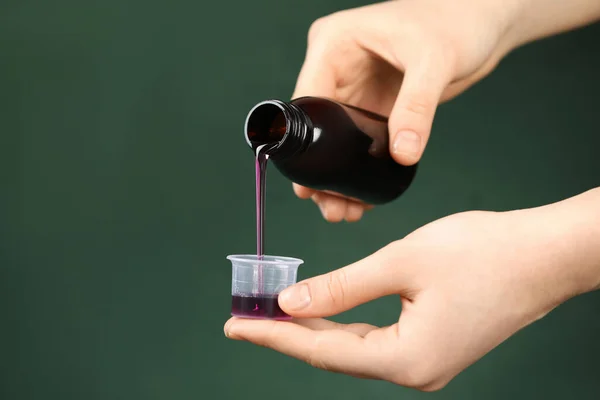 Woman Pouring Cough Syrup Measuring Cup Dark Green Background Closeup — Fotografia de Stock