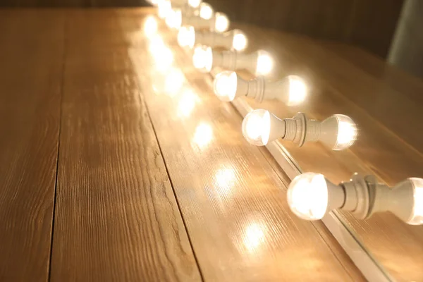 Modern Mirror Light Bulbs Wooden Table Closeup — Stock fotografie