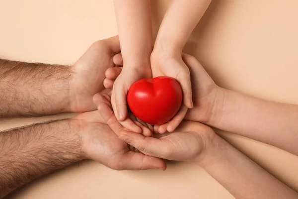 Parents Kid Holding Red Heart Hands Beige Background Top View — Zdjęcie stockowe