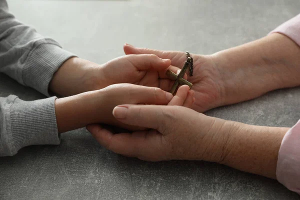 Boy His Godparent Holding Cross Grey Table Closeup —  Fotos de Stock