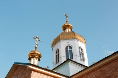 Village church against blue sky, low angle view