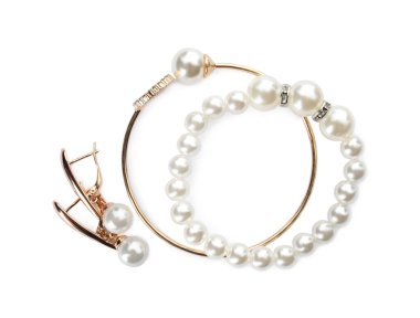 Different elegant jewelry with pearls on white background, top view