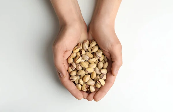 Woman Holding Tasty Roasted Pistachio Nuts White Background Top View —  Fotos de Stock