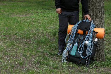 Hiker with backpack ready for journey outdoors, closeup. Mountain tourism