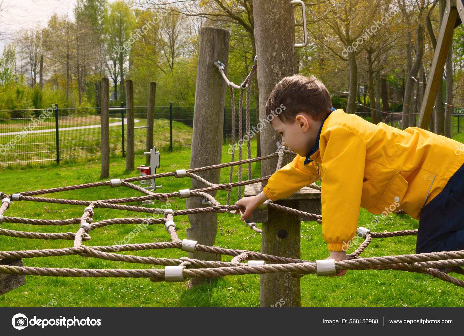 Little Boy Climbing Rope Net Playground — Stock Photo © NewAfrica #568156988