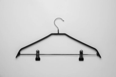 Empty hanger with clips on light grey background, top view
