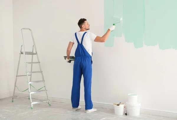 Man Painting Wall Light Blue Dye Indoors — Stockfoto