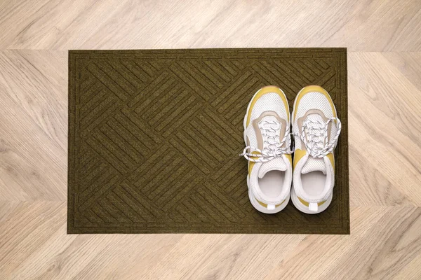 Stylish Door Mat Shoes Wooden Floor Top View — Stock Photo, Image