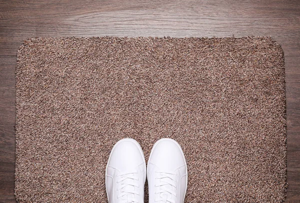 Stylish Door Mat Shoes Wooden Floor Top View — Stock Photo, Image