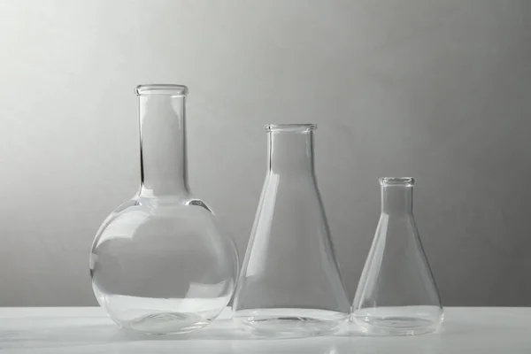Set Laboratory Glassware White Table Grey Background — Photo