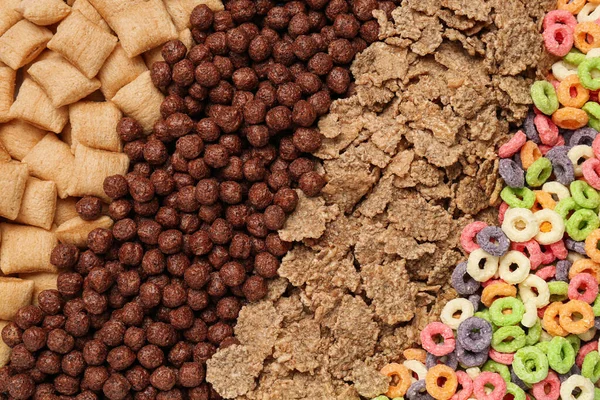 Different types of dry breakfast as background, top view