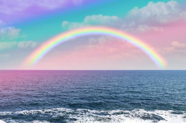 Beautiful view of colorful rainbow in sky over sea