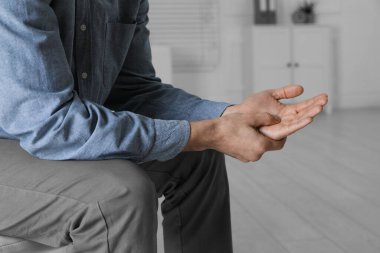 Tetik parmağından muzdarip bir adam, yakın plan.