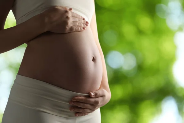 Young Pregnant Woman Touching Her Belly Outdoors Closeup Space Text — Foto de Stock