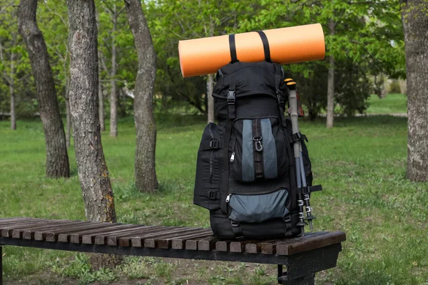 Backpack Camping Mat Trekking Poles Wooden Bench Park Space Text — Fotografia de Stock