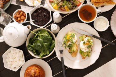 Many different dishes served on buffet table for brunch, flat lay