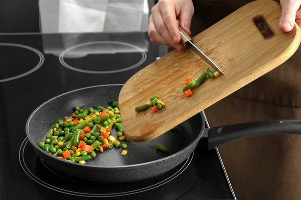Woman Putting Tasty Vegetable Mix Frying Pan Home Closeup — Stockfoto