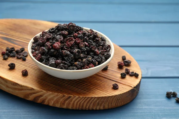 Bowl Dried Black Currant Berries Blue Wooden Table — Stock Fotó