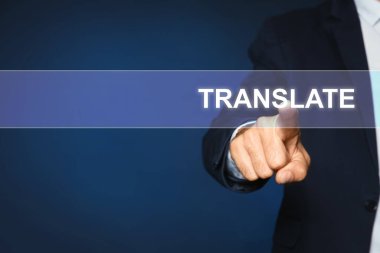 Man pointing at virtual model of word TRANSLATE against dark blue background, closeup