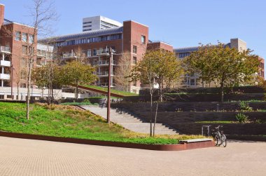 Cityscape with beautiful apartment buildings and cozy square on sunny spring day