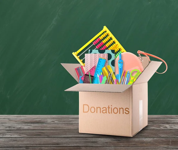 Donation Box Different School Stationery Wooden Table Chalkboard — Φωτογραφία Αρχείου