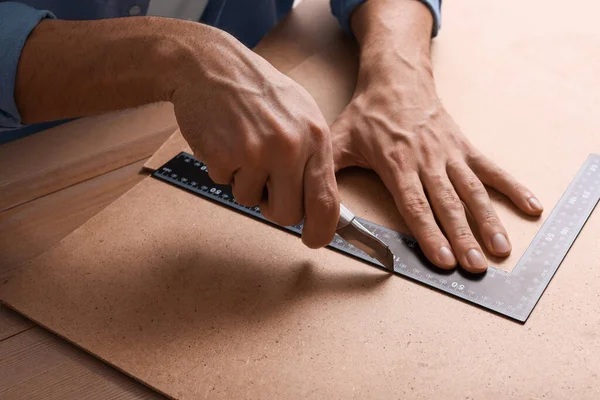 Man Cutting Chip Board Utility Knife Ruler Table Closeup — Stockfoto