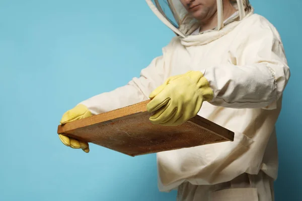 Beekeeper Uniform Holding Hive Frame Honeycomb Light Blue Background Closeup — стоковое фото