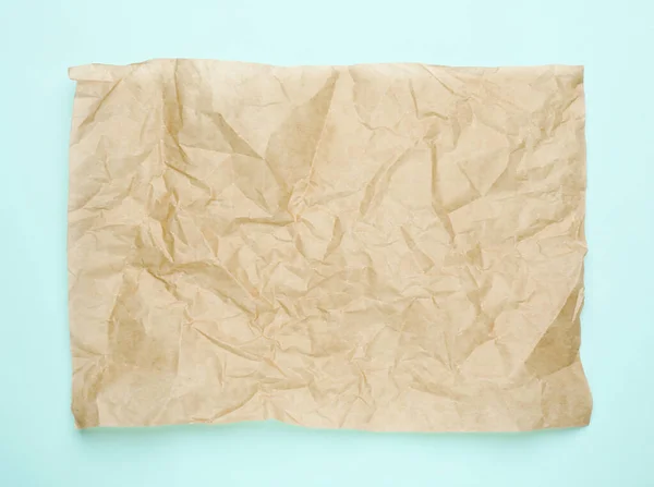 Sheet Crumpled Brown Baking Paper Light Blue Background Top View — Stock fotografie