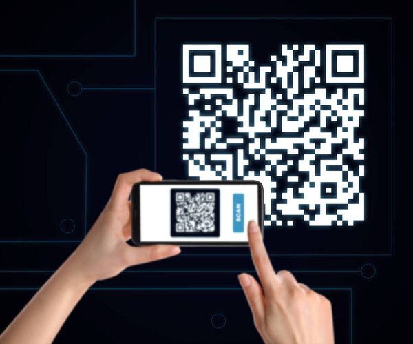 Woman scanning QR code with smartphone on black background, closeup