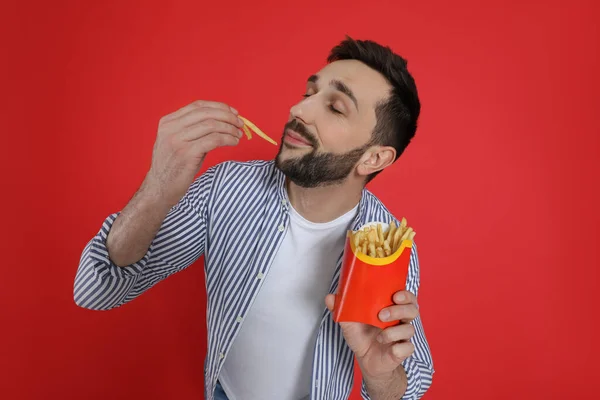 Man Eating French Fries Red Background — Stock Photo, Image