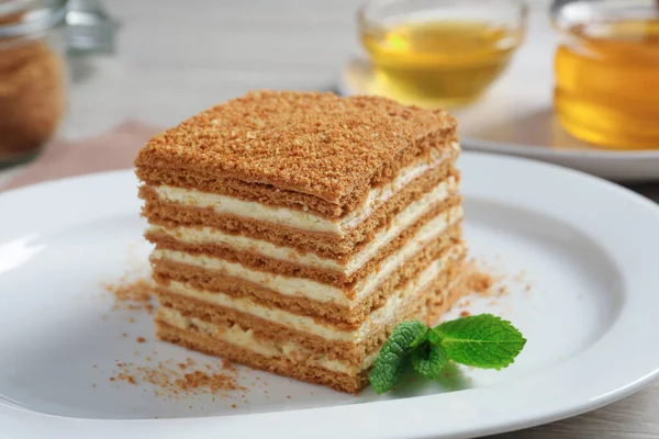 Slice Delicious Layered Honey Cake Mint Plate Closeup — стоковое фото