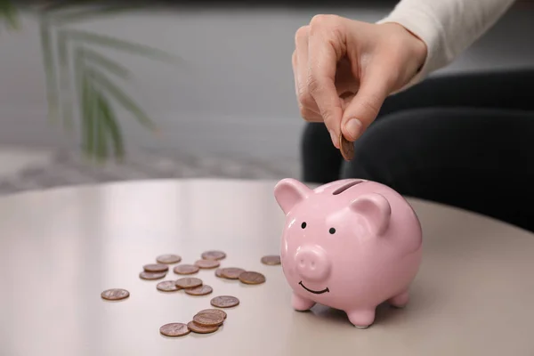 Woman Putting Money Piggy Bank Table Closeup Space Text — Stock Photo, Image