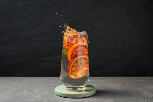 Delicious Refreshing Drink Sicilian Orange Splashing Out Glass Grey Table — Fotografia de Stock