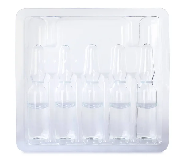 Glass ampoules with pharmaceutical product in tray on white background