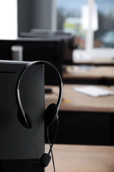 Modern computer with headset in office. Hotline service