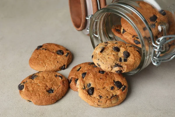 Overturned Glass Jar Delicious Chocolate Chip Cookies Light Grey Table — Stock Photo, Image