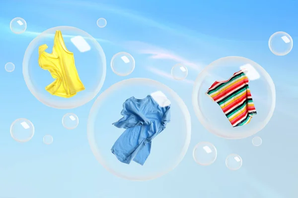 Washing powder bubbles with clothes against cloudy sky