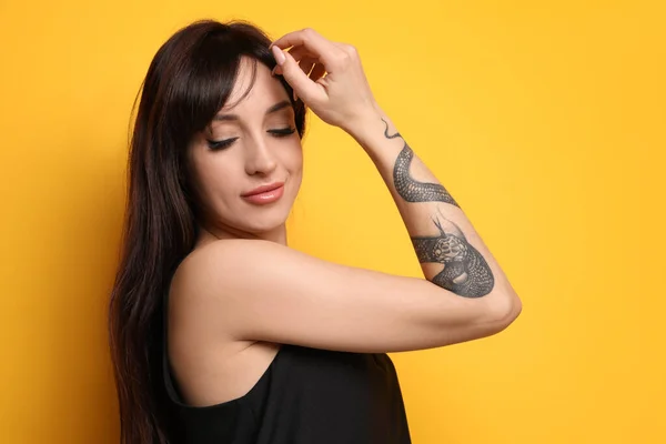 Mulher Bonita Com Tatuagens Braço Contra Fundo Amarelo — Fotografia de Stock