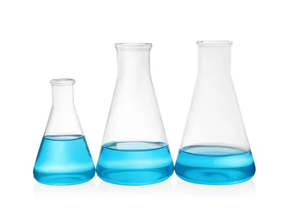 Different Laboratory Glassware Light Blue Liquid White Background — Stock Photo, Image