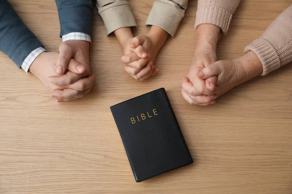 Boy His Godparents Praying Together Wooden Table Top View — Stockfoto