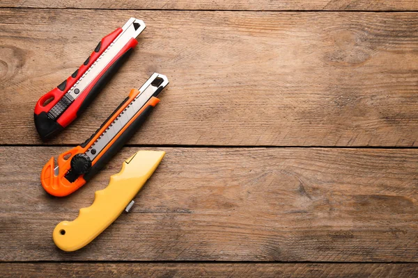 Different Utility Knives Wooden Table Flat Lay Space Text — Stock Photo, Image