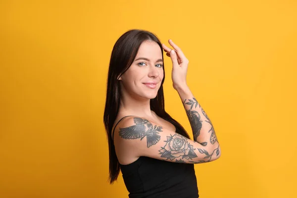 Mulher Bonita Com Tatuagens Braço Contra Fundo Amarelo — Fotografia de Stock