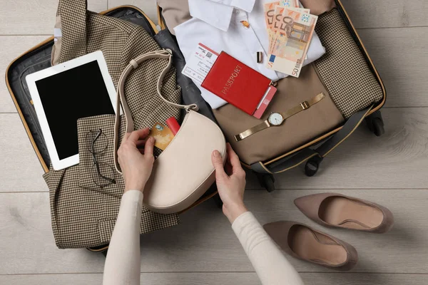 Woman Packing Suitcase Business Trip Wooden Floor Top View — Stock fotografie