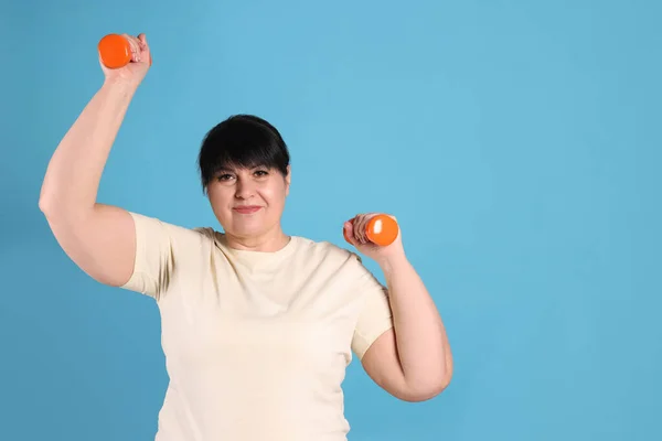 Happy Overweight Mature Woman Doing Exercise Dumbbells Light Blue Background — стоковое фото
