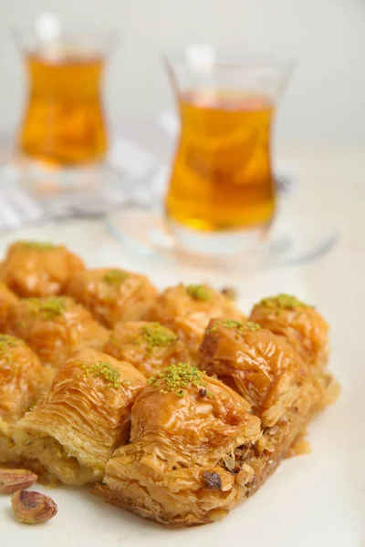 Delicious sweet baklava with pistachios on table, closeup