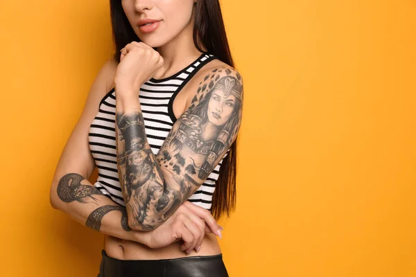 Mulher Bonita Com Tatuagens Nos Braços Contra Fundo Amarelo Close — Fotografia de Stock