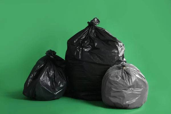 Trash Bags Full Garbage Green Background — Stok fotoğraf