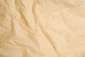 Textura zmačkaného hnědého pečiva jako pozadí, detailní záběr